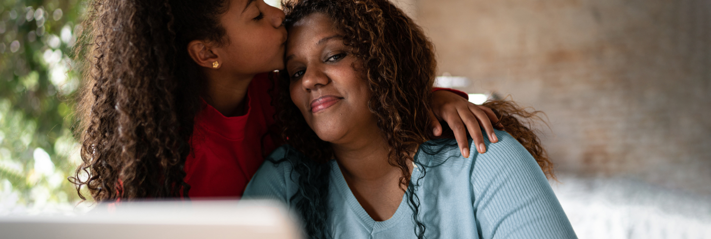 Daughter embracing her mother